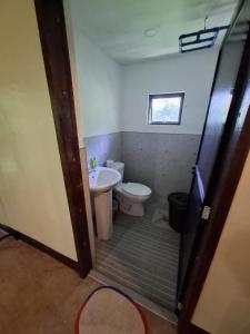 a bathroom with a toilet and a sink at Izzahjay homestay in Burgos