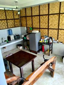 a kitchen with a table and a refrigerator at Izzahjay homestay in Burgos +9 photos
