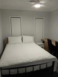a bed with two pillows on it in a room at Serene Home in Bahrs Scrub +5 photos