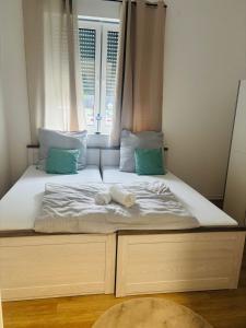 a bed with two pillows and a window at Zentrales, neumodernes Apartmentment Püttquartier No 3 in Ibbenbüren