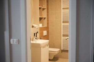 a small bathroom with a toilet and a sink at Apartment Nuve in Bjelašnica