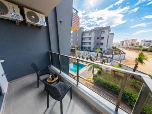 a balcony with chairs and a view of the beach at Dorado Suit in Aksu