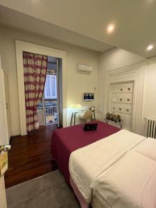 a bedroom with a bed and a table and a window at Donnalbina 7 The Fresh BB in Naples