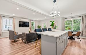 a kitchen and living room with a table and chairs at Spacious House with King Beds in Prime Location in Bloomfield