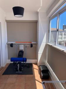 a room with a blue chair and a window at The Villa On Fontana in Yzerfontein