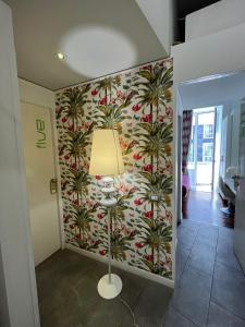 a hallway with a wall mural of palm trees at Donnalbina 7 The Fresh BB in Naples +37 photos