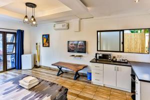 a kitchen with white cabinets and a table at Van Gogh in Ballito