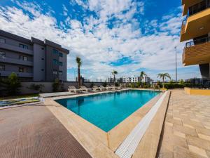 a swimming pool in front of a building at Dorado Suit in Aksu