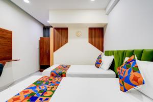 a hotel room with two beds at FabHotel Leon Square in Bengaluru