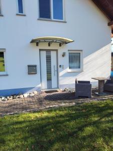 a door of a house with a table and a patio at Ferienwohnung in Hornstein in Bingen