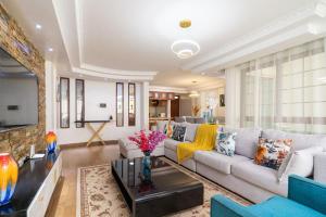 a living room with a couch and a table at Luxurious Nairobi Apartment with Shared Pool and Modern Amenities in Nairobi