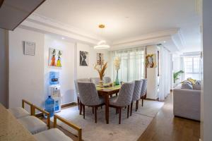 a dining room with a table and chairs at Luxurious Nairobi Apartment with Shared Pool and Modern Amenities in Nairobi