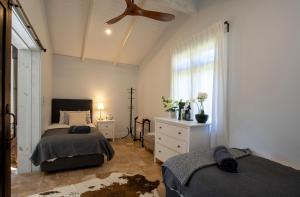 a bedroom with two beds and a ceiling fan at Webbs Creek Farm Retreat in Wisemans Ferry +35 photos
