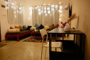 a living room with a table and a couch at The Cozy Nest in Rishīkesh