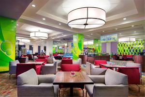 a restaurant with couches and tables in a mall at Holiday Inn Express Zhengzhou Zhongzhou by IHG in Zhengzhou