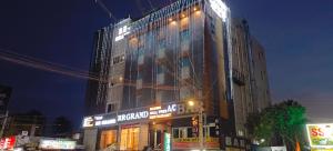 a large building with lights on the side of it at RR Grand Inn in Coimbatore