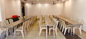 a conference room with a long table and chairs at RR Grand Inn in Coimbatore