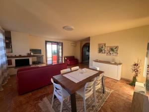 a living room with a table and a couch at Belvedere House Peccioli in Peccioli