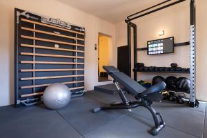 a room with a gym with a chair and weights at Hannah Formentera in Playa Migjorn