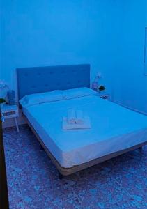 a bed in a room with a blue light at Apartalux Playa Arenal in Burriana