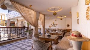 a lobby of a restaurant with tables and chairs at Riad Hamdane Rooftop & SPA in Marrakesh