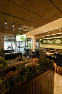 a restaurant with tables and chairs and a sign that reads the food hall at The Food Villa in Jāmb