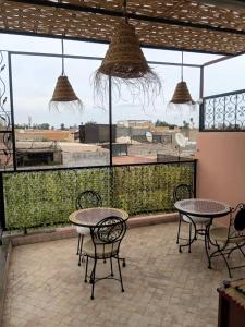 a patio with tables and chairs and a large window at Riad Le Bijou de Zahra Marrakech Kasbah in Marrakech +36 photos