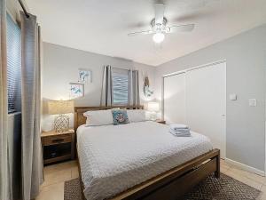 a bedroom with a bed and a ceiling fan at Largo Pool House Firepit Pet Friendly in Largo +69 photos