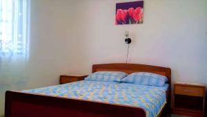 a bedroom with a bed with two pillows at Apartment Ribarica - Velebit Riviera 38418 in Ribarica