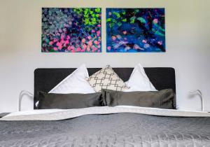 1 dormitorio con 1 cama con 2 cuadros en la pared en Schlafort, en Porta Westfalica