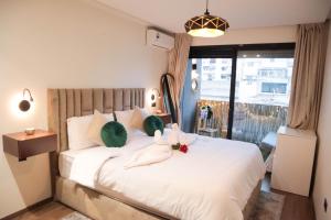 a bedroom with a bed with two stuffed animals on it at R108- Gorgeous & Cosy Aprt with Wifi, Parking and Gym at the heart of Bourgogne in Casablanca-Port