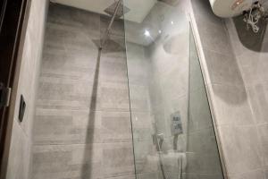 a bathroom with a shower with a glass door at R108- Gorgeous & Cosy Aprt with Wifi, Parking and Gym at the heart of Bourgogne in Casablanca-Port +41 photos