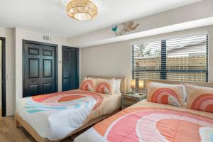 a bedroom with two beds and a window at Lux 6br5ba, Htd Pool, Hot Tub, Game Rm Sleeps 22 in West Bradenton +40 photos