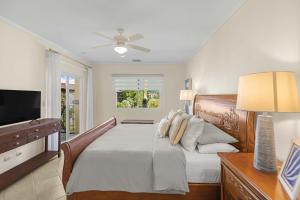a bedroom with a bed and a flat screen tv at Del Mar 5F 3 bdr Garden View in Los Suenos in Herradura