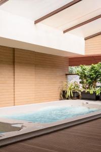 an indoor swimming pool in a house at YU Hotel Candolim in Candolim