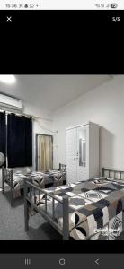 a room with three beds in a room at Sharing flat for LADIES ONLY in Sharjah