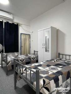 a room with three beds in a room at Sharing flat for LADIES ONLY in Sharjah
