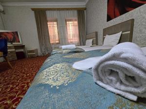 a hotel room with two beds with towels on them at Sarp Hotel in Baku