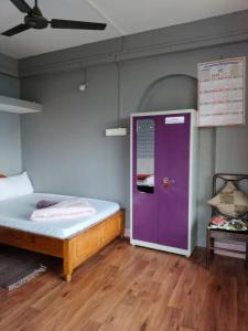 Ένα ή περισσότερα κρεβάτια σε δωμάτιο στο Serenity Homestay by Nature's Nook