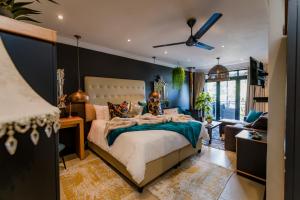 a bedroom with a bed and a living room at SW1 Lodge in Somerset West