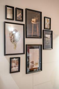 a group of pictures hanging on a wall at Loft Rooms Suite B&B in Santeramo in Colle