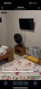 a picture of a room with a bed and a television at Pousada Casa de Geralda in Altaneira