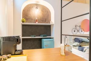 a kitchen with a table and a bike on a shelf at Loft Rooms Suite B&B in Santeramo in Colle +47 photos