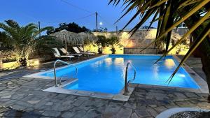 a swimming pool with blue water in a resort at Cittadella Asprovalta 3BR - private pool in Asprovalta
