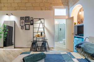 a bedroom with a ladder and a room with a bed at Loft Rooms Suite B&B in Santeramo in Colle