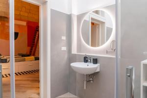 a bathroom with a sink and a mirror at Loft Rooms Suite B&B in Santeramo in Colle