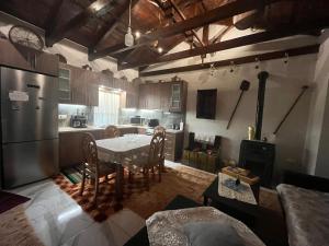 a kitchen with a table and chairs and a stove at Despo's Guest House in Kandíla