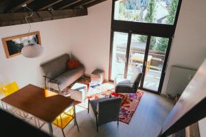 an overhead view of a living room with a table and chairs at Casa Laret 6-12 in Laax-Murschetg +25 photos