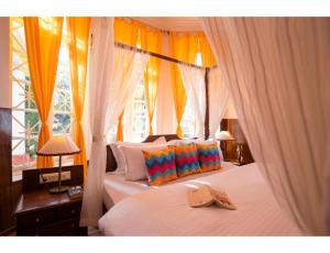 Ένα ή περισσότερα κρεβάτια σε δωμάτιο στο goSTOPS Ooty +69 φωτογραφίες