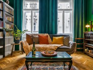 a living room with a couch and a table at Timeless Prague Apartment by House of Huxe in Golčŭv Jeníkov